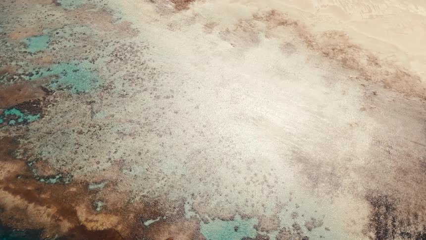 The blue water is on the beach