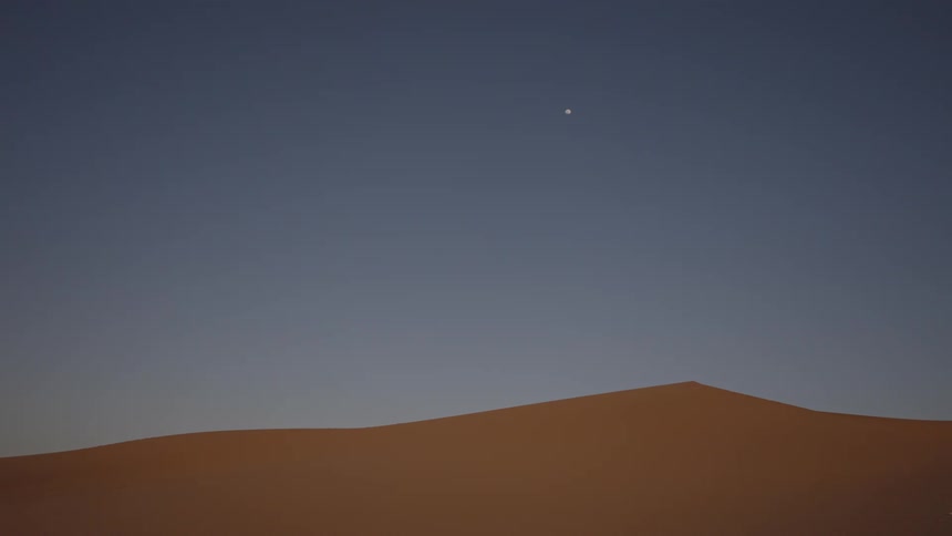 Sun setting in the horizon of a desert landscape