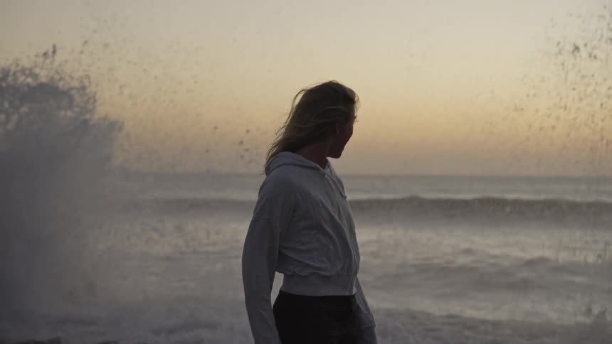 Woman standing in front of water