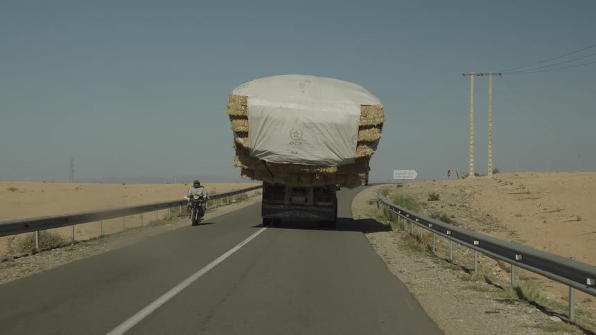 A footage of a truck with heavy load moving on the road