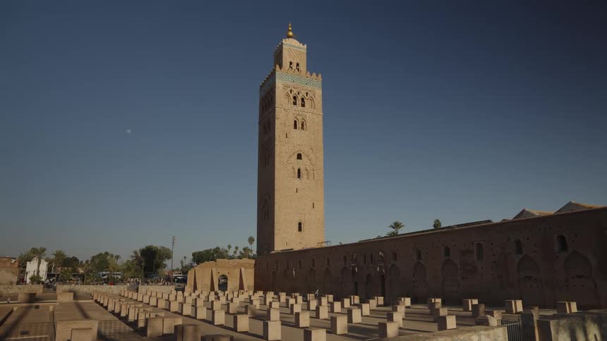 Patterned concrete blocks on the edge of a classical architecture with a tower in the background