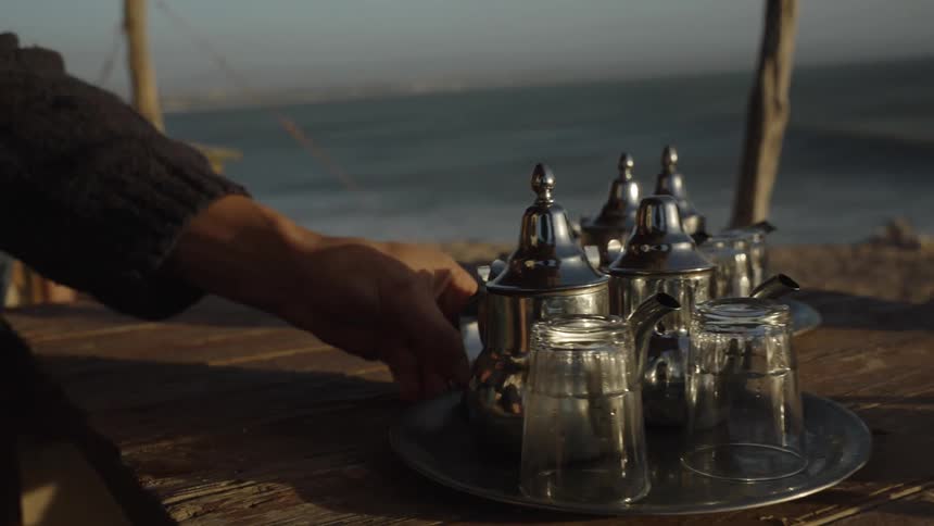 A tray with drinks is moved on the beach