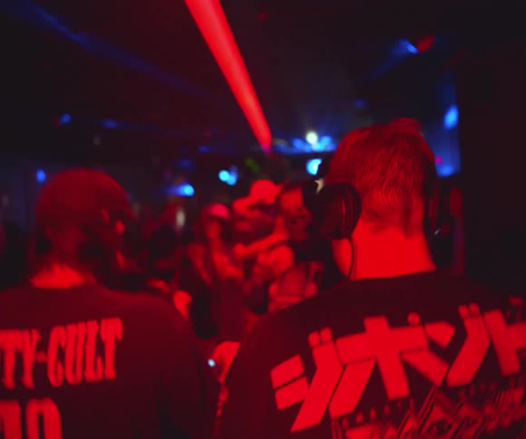 A couple of djs entertaining people at a club