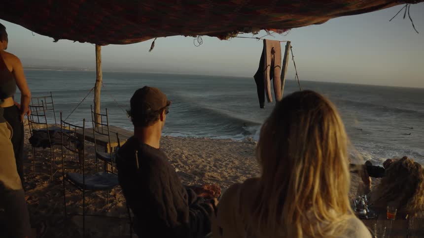 Friends are watching the ocean on the beach
