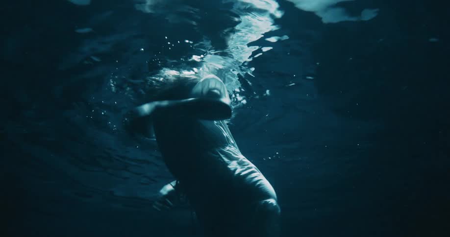 Underwater view of a woman swimming desperately