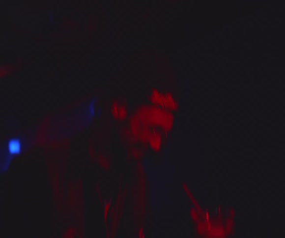 A footage of a man dancing in the club while holding his drink