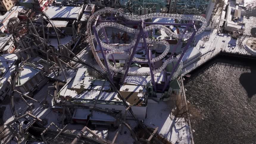 Aerial of a roller coaster in an amusement park on a winter day