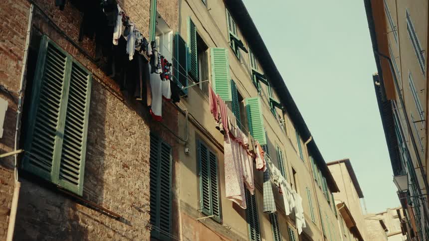 Laundry hung out on close lines out of apartment windows