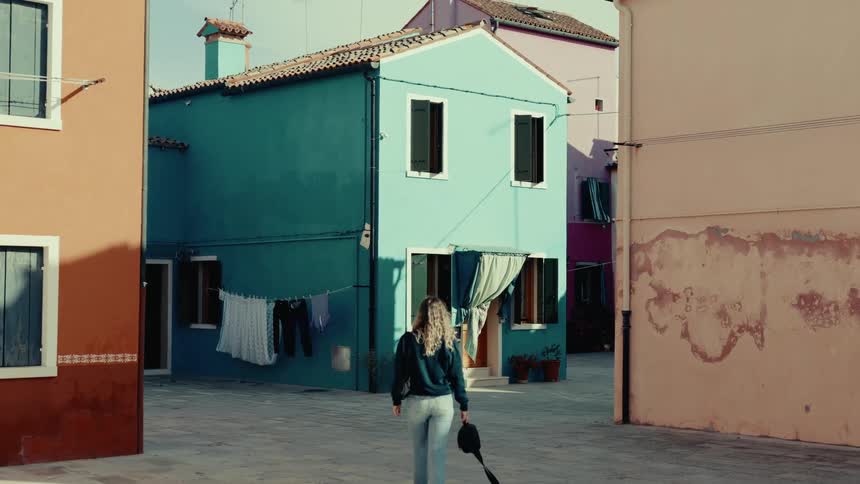Woman walking in a suburb with classical architecture