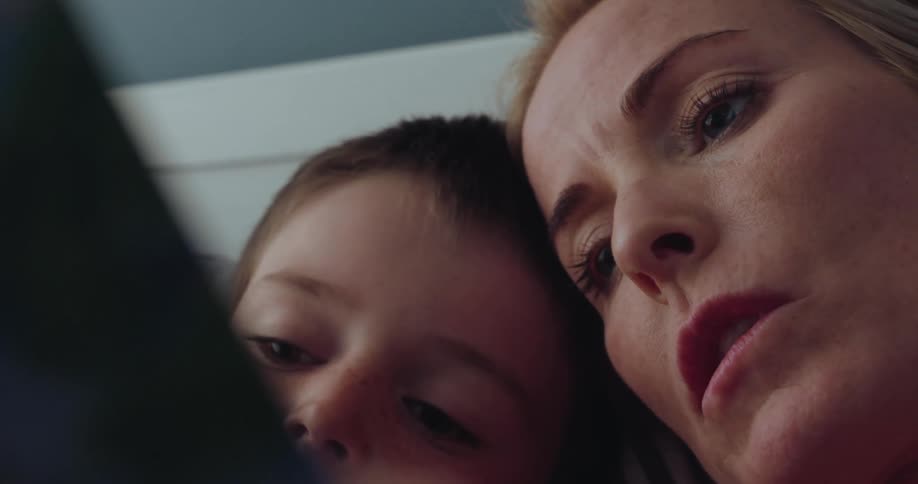 A mother is reading to her son