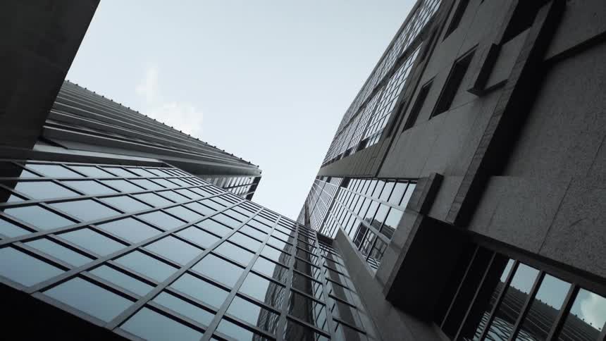 Upward view of an urban building against a blue sky