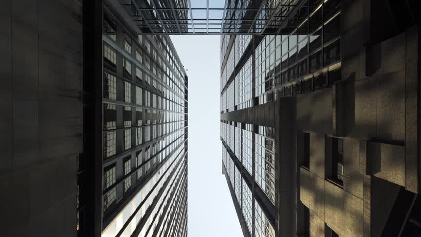 Tall buildings fill the cloudy sky
