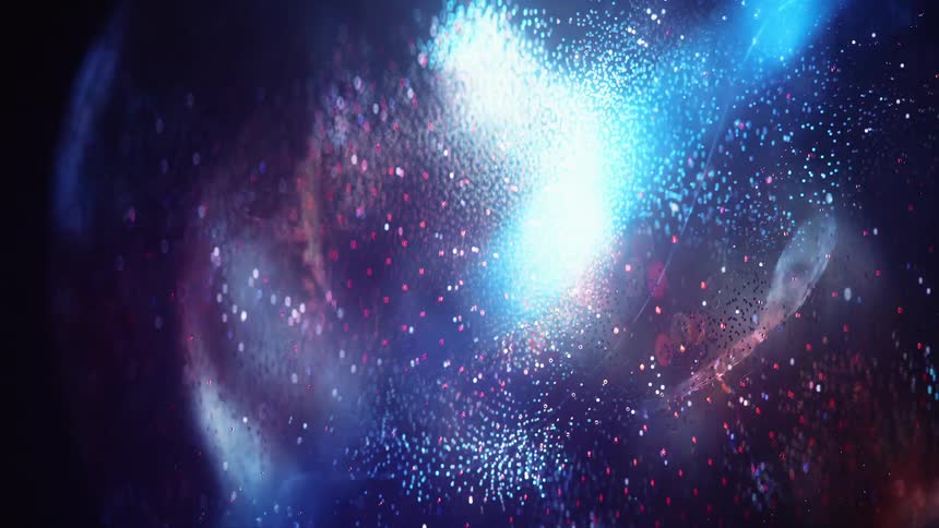 A spherelike form composed of glowing blue red and white particles morphs and swirls dynamically against a dark backdrop