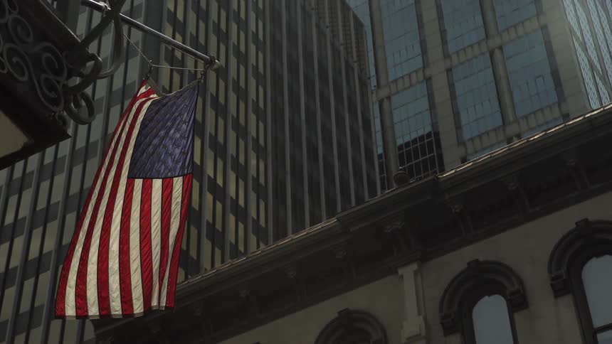 The american flag hangs from the building