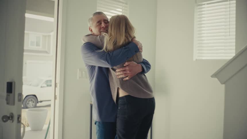 Woman running through the house and hugging a man