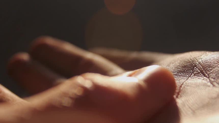 A person traces a finger across their hand