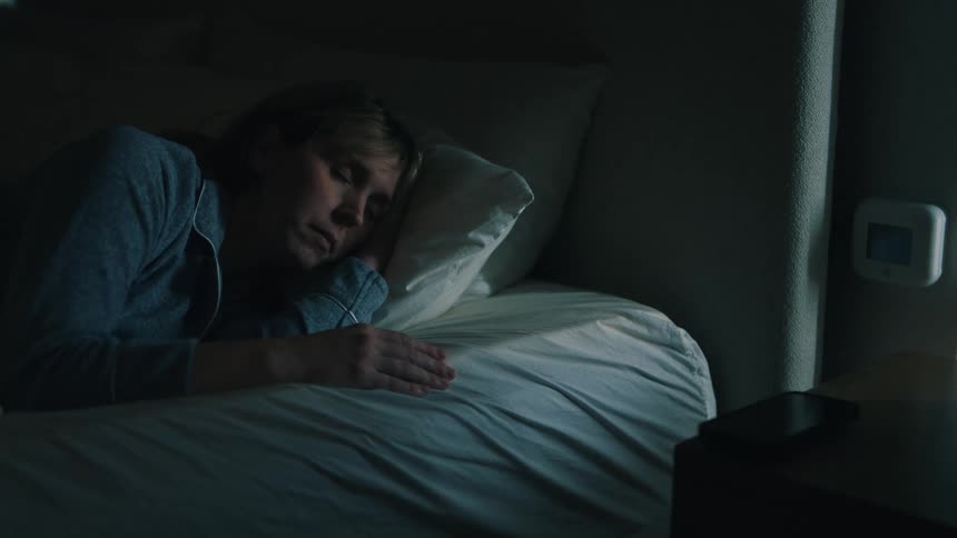 A woman is sleeping in her bedroom