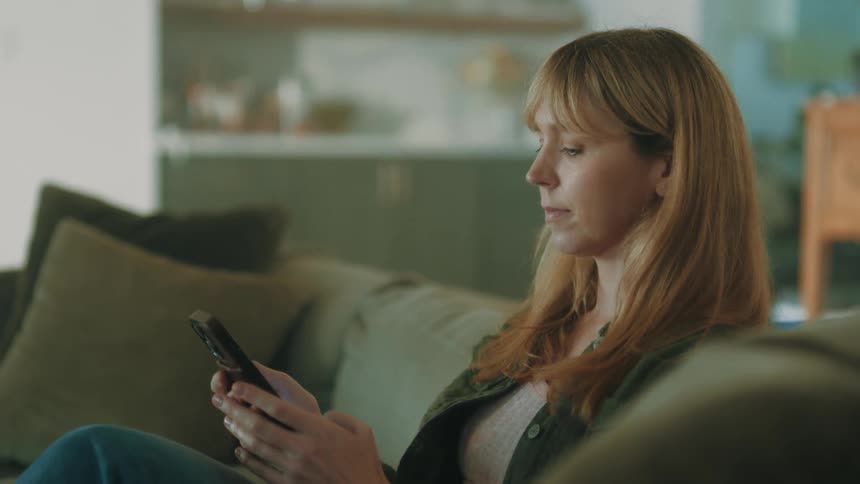 A close up footage of a lady operating a smartphone