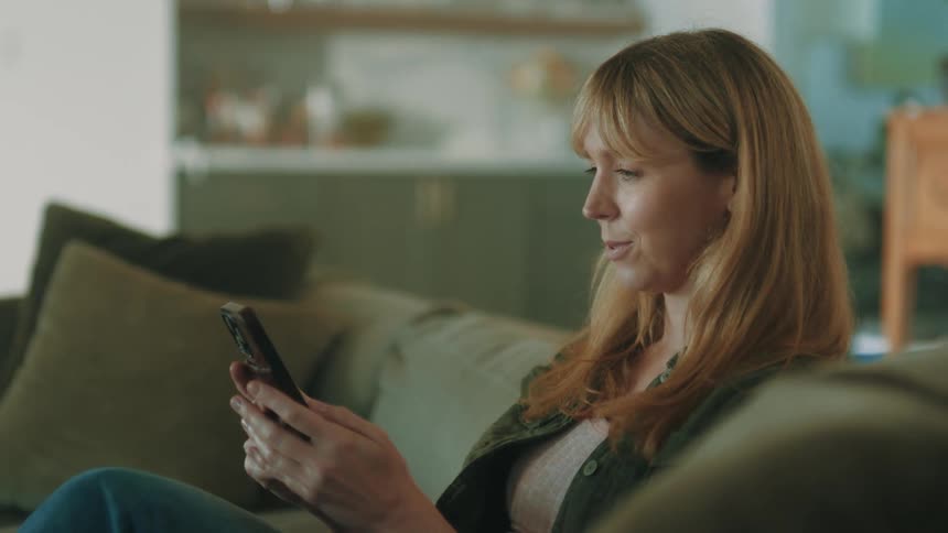 A footage of a lady operating a smartphone
