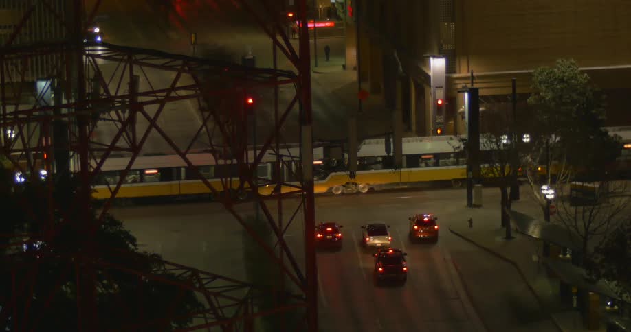 Cars stop for a train to pass in the city
