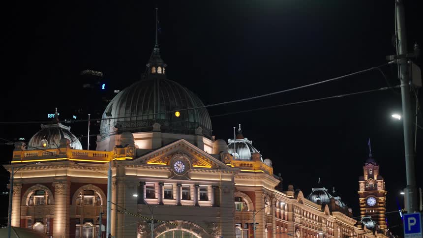 An old train station at night with a bird flying nearby
