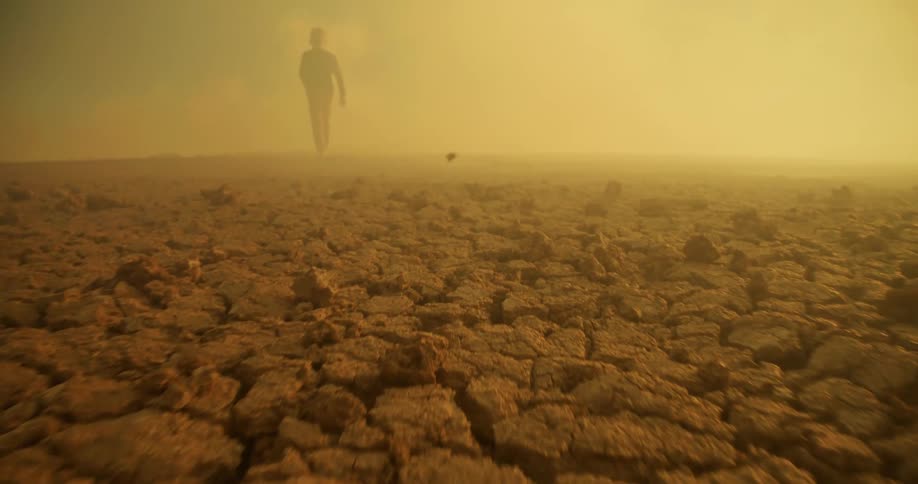 A man is walking through the thick fog