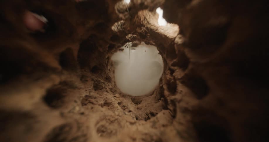 Smoke shoots through the stone tunnel