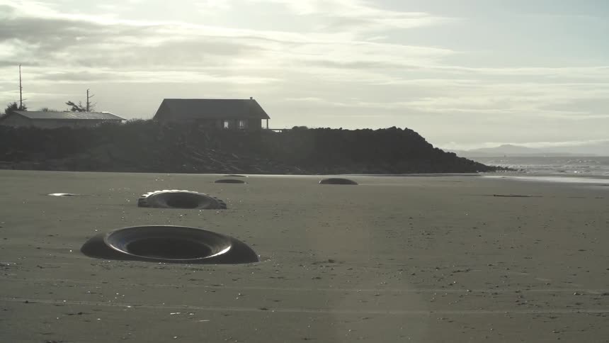 A bunch of tires on a beach