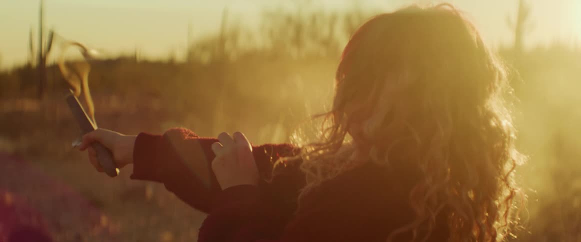 A girl fires a slingshot on the field