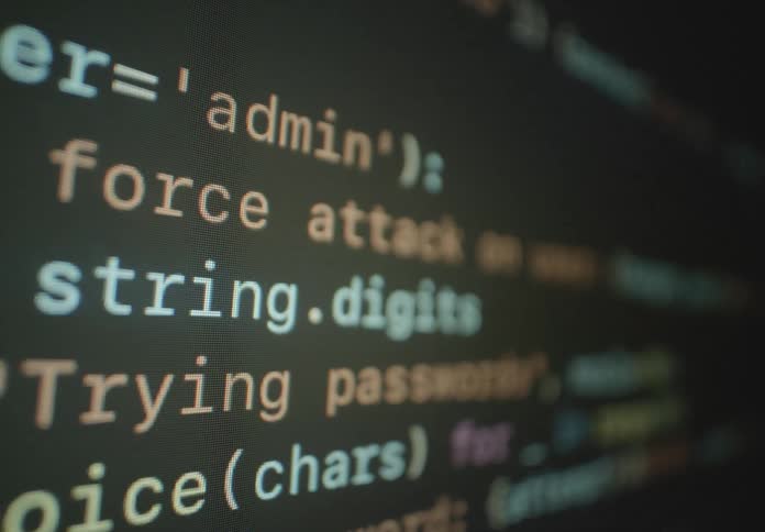 Computer code is displayed on the screen