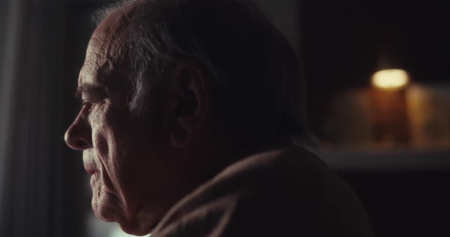 A man begins laughing in the dark room
