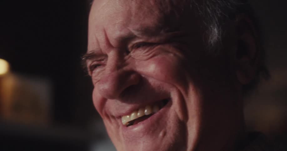 A man is laughing at home