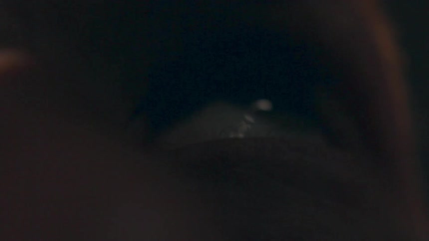 A person is blinking as light hits their eye