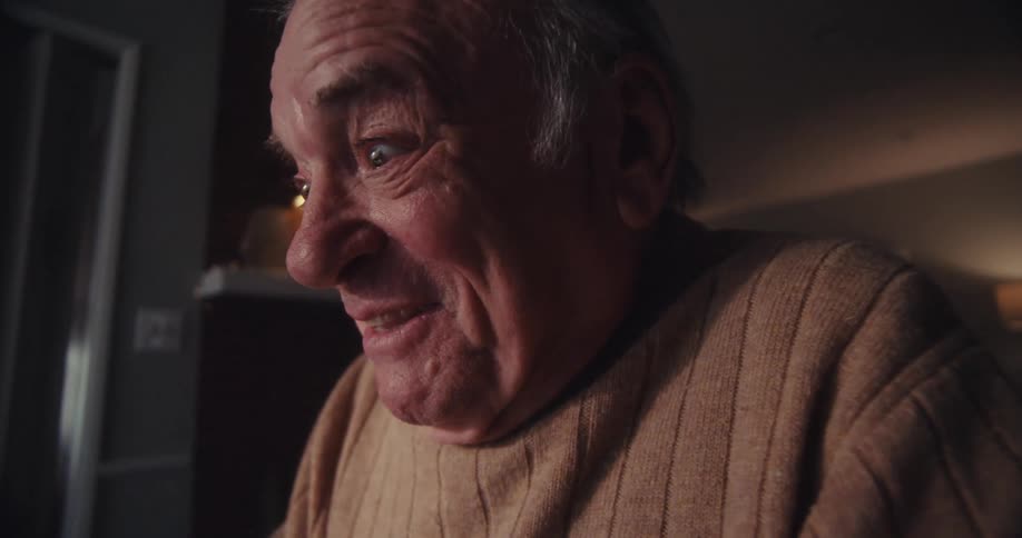 A man is laughing and waving his hands