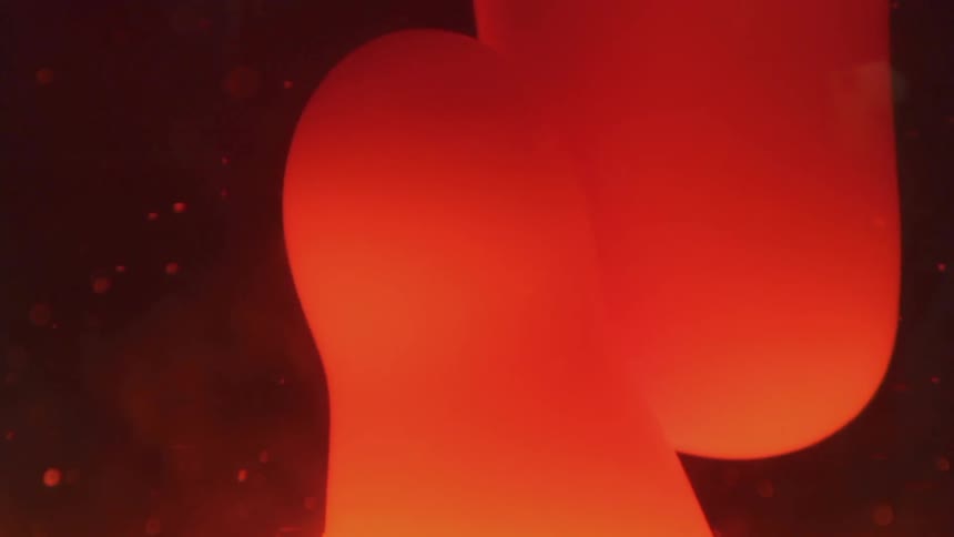 A lava lamp is lit moving around the contents