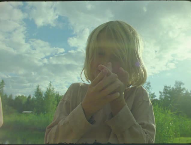 Children look at a bug on a boys finger