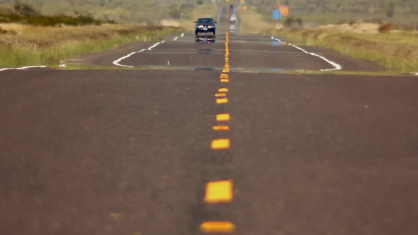 A car is traveling down this long road