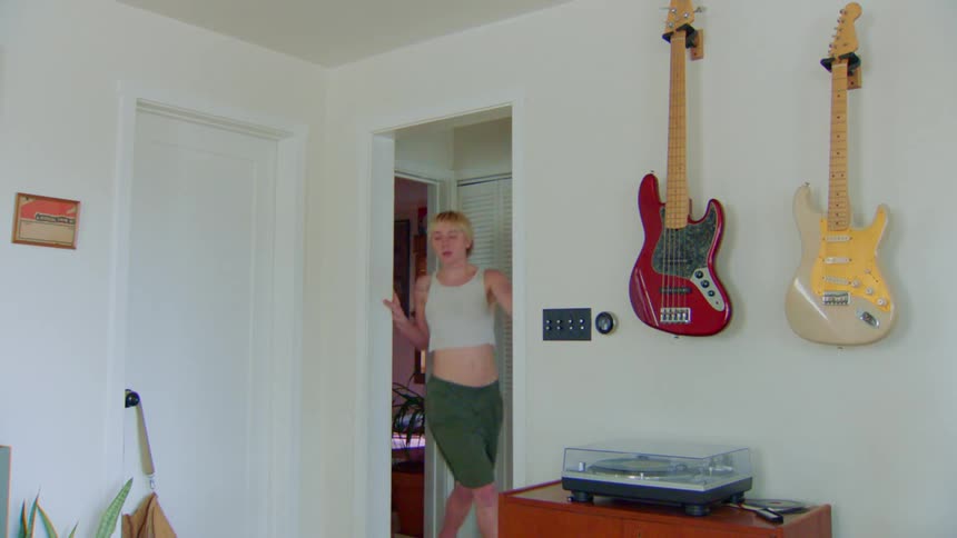 A woman dances and spins through the room