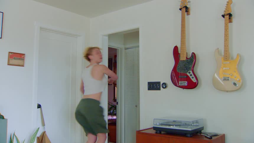 A woman spins repeatedly while traveling through the room