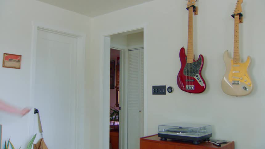 A woman jumps into the room dancing