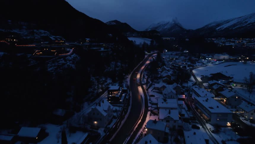 Cars drive in the small village by the mountains