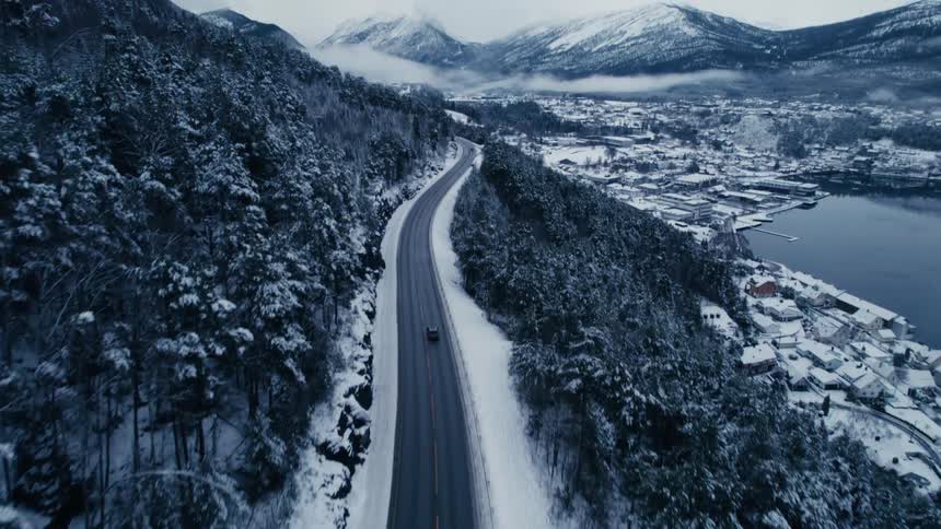 A winding road is on the mountain above the town