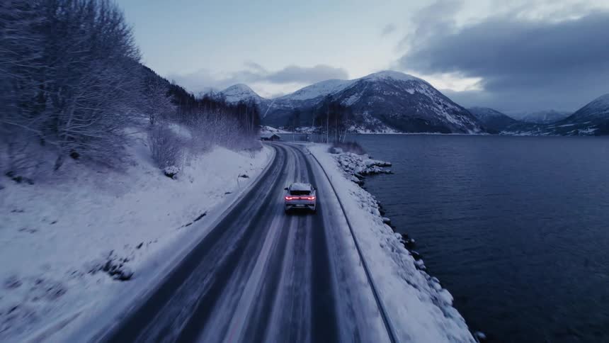 The car is driving towards the mountain