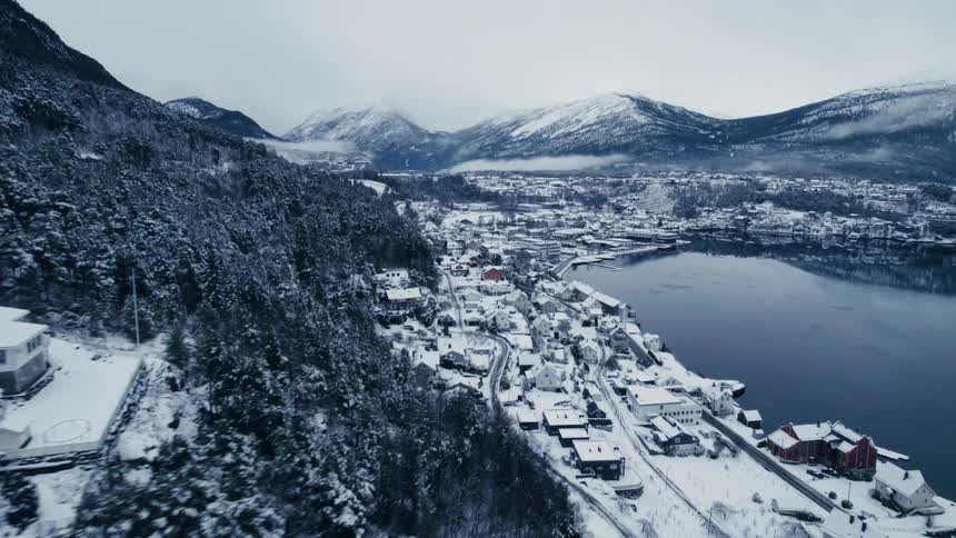 Aerial view of a town by the mountains and the sea