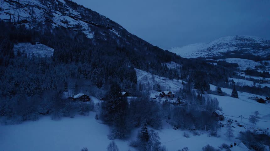 Scene of houses scattered at the foot of a snowcovered mountain