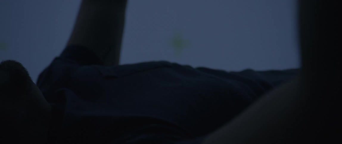 A man is floating in the air whit his arms up while the wind is blowing through his hair