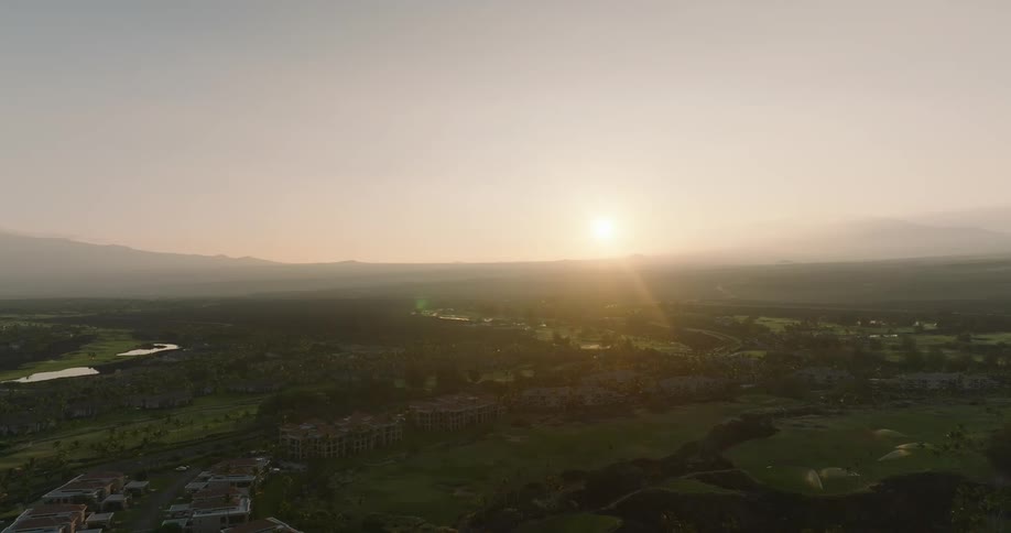 A city skyline is visible on a sunny evening