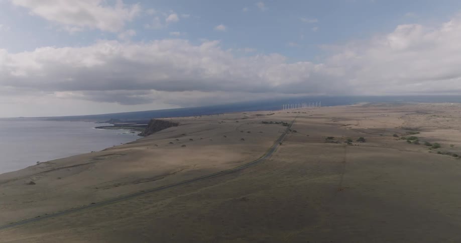 An island by the coast features grassland and a road all covered in mist