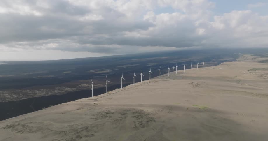 The row of windmills turn by the cliff
