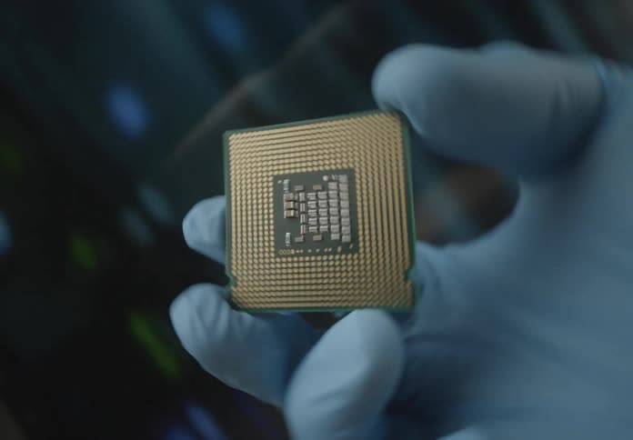 A person holds a cpu with a rubber glove